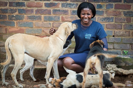 Lumka Golintete with dogs rescued by CLAW