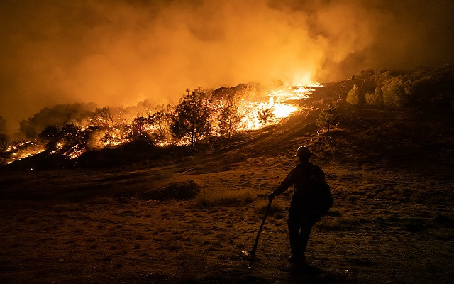 Wildland Firefighter crews work throughout the night as they backburn areas of the Caldor Fire to prevent further spread. California, USA, 2021. Nikki Ritcher / We Animals Media
