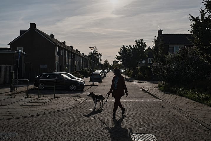 Eva Meijer takes Doris, a dog rescued from Romania who now lives with her, for a walk in her neighbourhood. North Holland, Netherlands. 2022. Sabina Diethelm / #unboundproject / We Animals Media