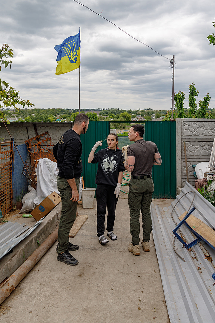 As they transfer to an animal shelter the last of 13 puppies evacuated from a region occupied during the Russia-Ukraine war, shelter volunteer Julia (middle) and UAnimals team members Vlad (L) and Danya (R) discuss the puppies' shelter accommodation. Ukraine, 2024. Anzhelika Kozachenko / UAnimals / We Animals Media